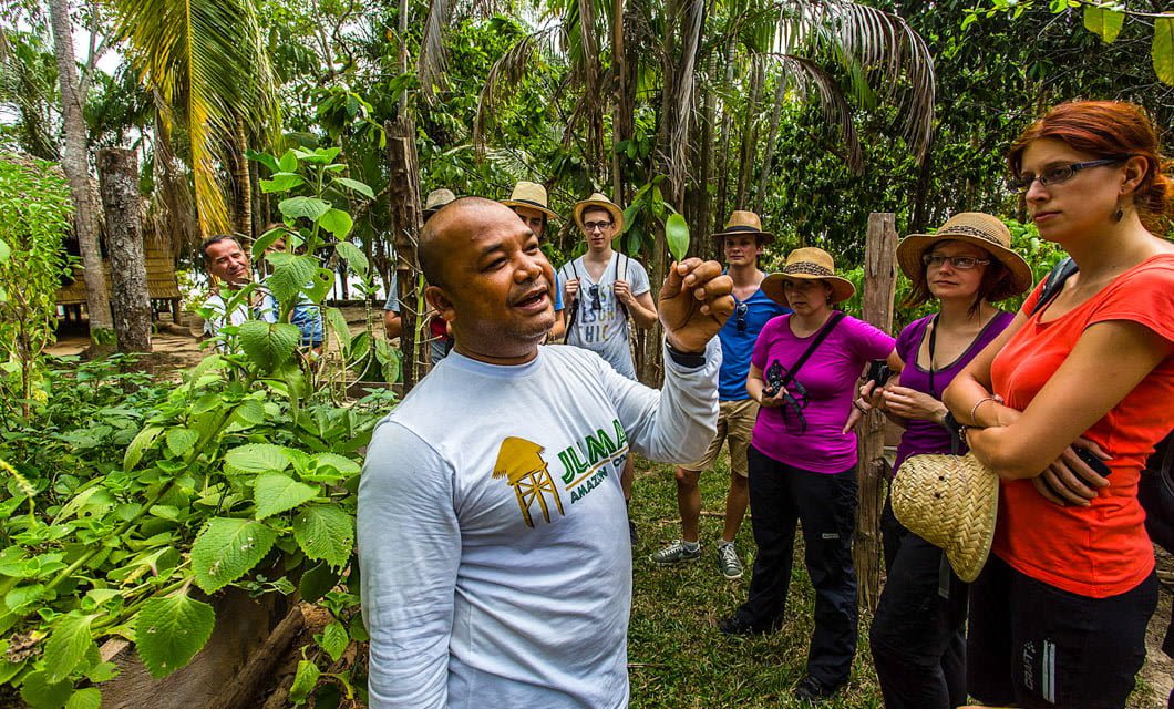 Tour guide speask to group in jungle