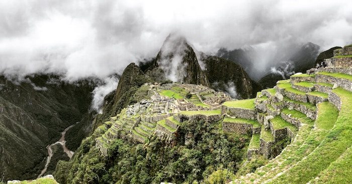 woman at Machu Picchu petting a llama