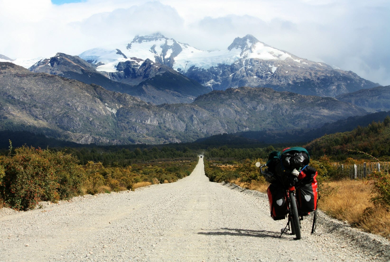 Empty highway running parallel to the Andes on a Patagonian road trip