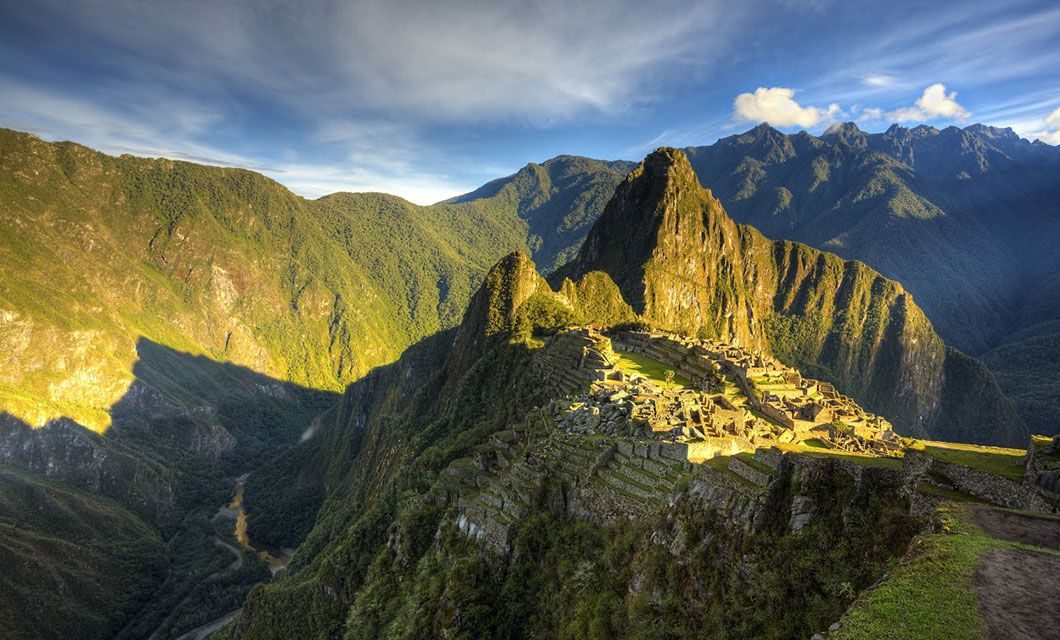 Machu Picchu citadel and terraces below Huayna Picchu, with cloud over the surrounding peaks