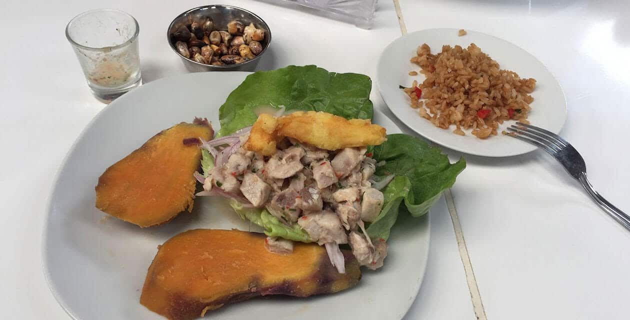 Peruvian ceviche on lettuce with sweet potato and red onion, toasted corn on the side